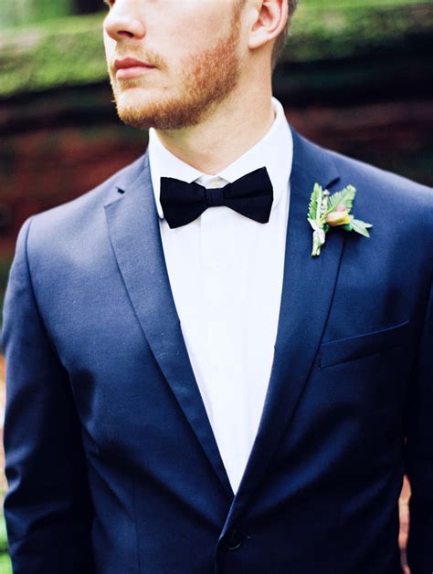 blue suit black bow tie.